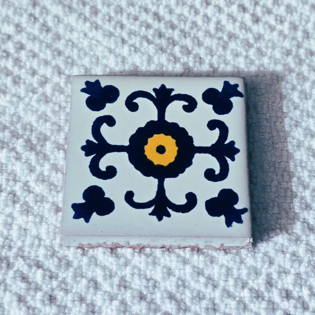 Decorative tile with intricate blue pattern.