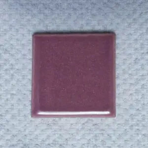 Purple square tile on textured surface.