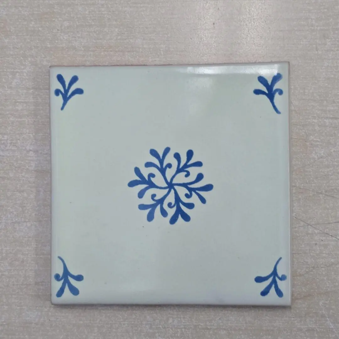 White tile with blue floral pattern.