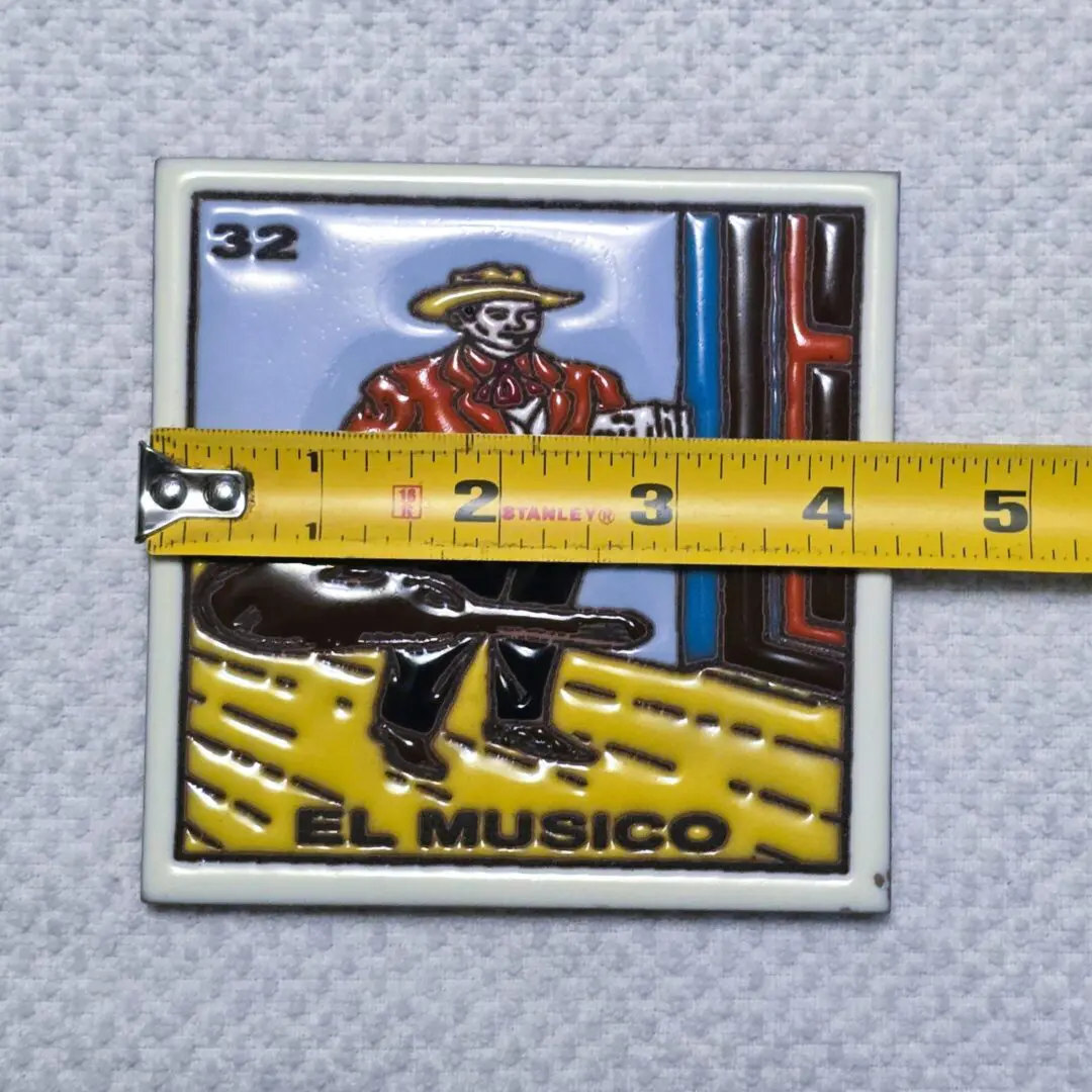 Tile with musician design and measuring tape.