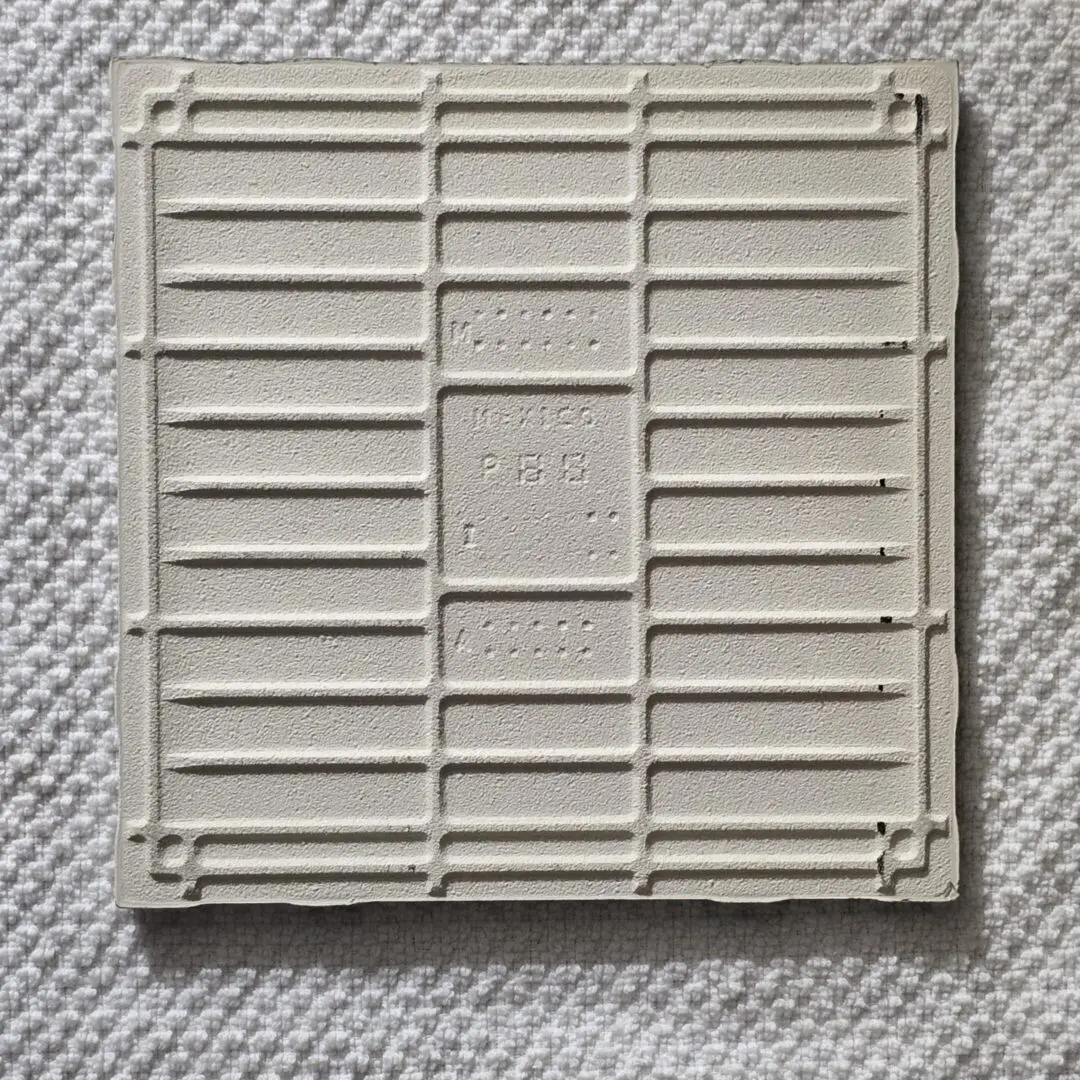 Square grid pattern on textured surface.