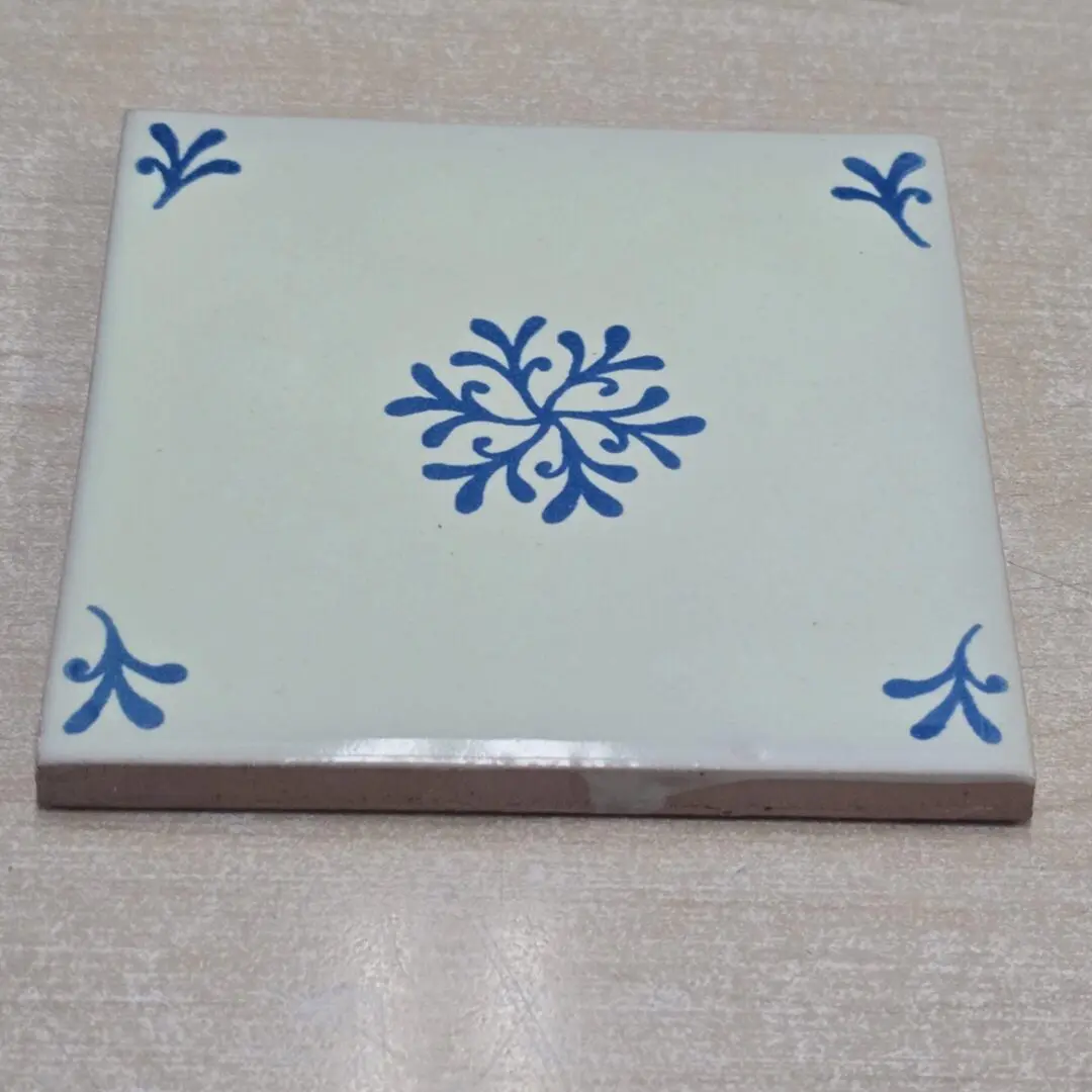 Ceramic tile with blue floral pattern.